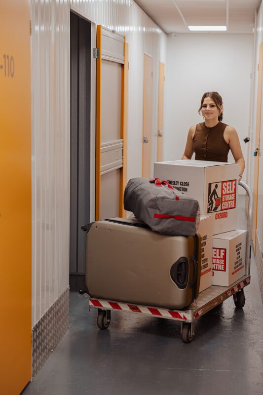 woman putting her personal things inside her personal self storage room